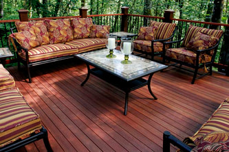 A collection of outdoor furniture arranged on a red Meranti deck constructed by Timbermann.