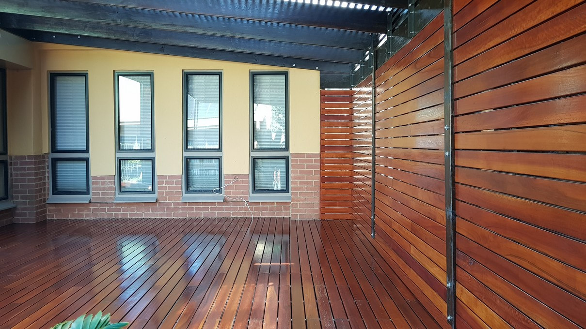 The outdoor space features a beautiful red ironbark patio and CCA pine roofing built by Timbermann.