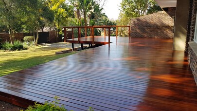 Skilled Timbermann employees prepare to install an exquisite red ironbark patio deck, exemplifying their expertise.